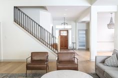 a living room filled with furniture and a stair case