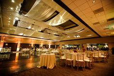 a banquet hall with tables and chairs set up for an event