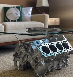 an engine block coffee table with glass top