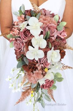 a bridal holding a bouquet of flowers and greenery