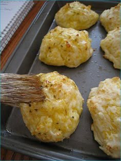 an egg muffin being brushed with a brush