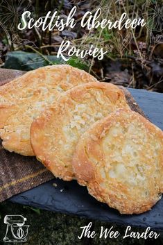 three biscuits sitting on top of a wooden table