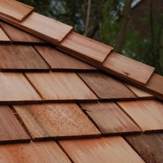 a close up view of a roof made out of wooden planks and shingles