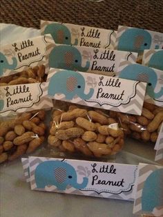 peanuts are wrapped in plastic bags and labeled with little peanut's for baby shower favors