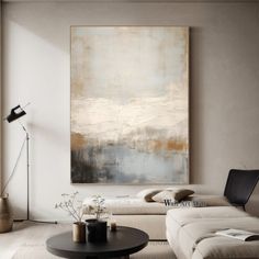 a living room filled with furniture and a large painting hanging on the wall above it