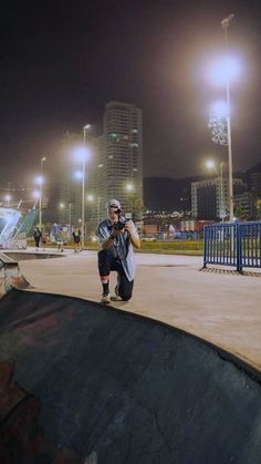 a man riding a skateboard up the side of a ramp at a skate park