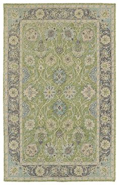 a green and blue rug with an ornate design