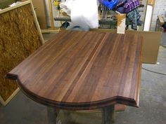 a wooden table being worked on in a shop