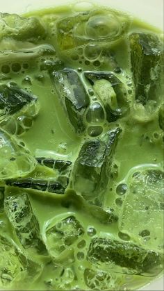 green liquid in a bowl filled with ice cubes