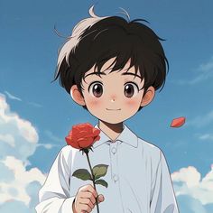 a young boy holding a flower in front of a blue sky with clouds behind him