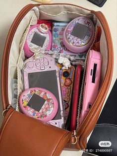 a purse filled with lots of different types of electronic devices