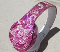 the hello kitty headphones are covered in pink swarongs and sparkles