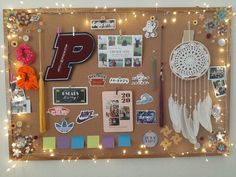 a bulletin board covered in magnets, pictures and other items with lights around it