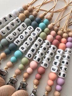 the beads are all different colors and have words on them