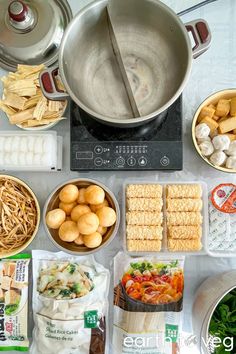 an assortment of food is displayed on a table with utensils and other items