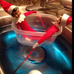 an elf is sitting in the sink with his legs spread out