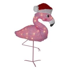 a pink flamingo with a santa hat on it's head is standing in front of a white background