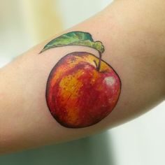 an apple with a green leaf on the side of it's arm, painted red and yellow