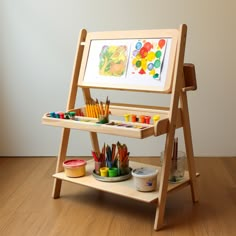 a child's art easel with paints and crayons