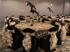 a banquet room set up with black and gold decorations