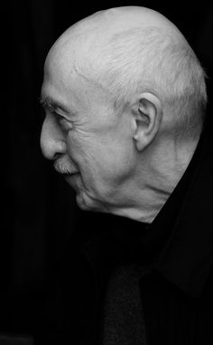 black and white photograph of an older man with bald hair looking off to the side