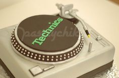 there is a cake that says technic on top of the dj's turntable