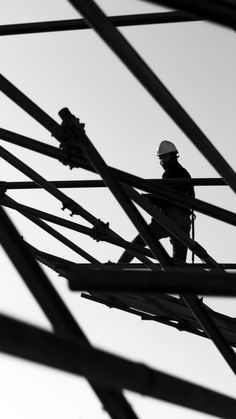 a man standing on top of a metal structure