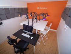 a room with several microphones on the wall and a computer desk in front of it