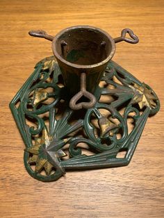 a small metal cup sitting on top of a wooden table