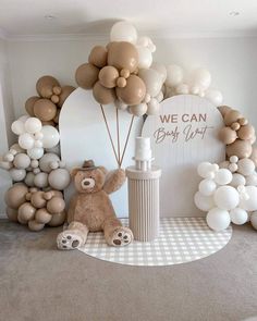 a teddy bear sitting in front of balloons and a sign that says we can baby shower