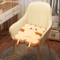 a white chair with a sheep shaped cushion on top of it in a room next to a dresser