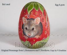 a painted egg with a rat in the center