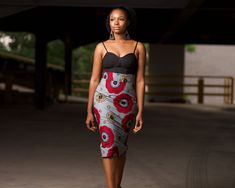 The Odaro Midi Pencil Skirt is a timeless and elegant addition to any wardrobe. This high-waisted skirt is crafted from authentic Ankara fabric, featuring a striking African print in shades of red, gold, and grey. The fitted design beautifully accentuates your curves, while the back slit adds a touch of sophistication and ease of movement. Lined for comfort and featuring a zip fastening at the back, this skirt is perfect for both professional and casual settings. Embrace the fusion of tradition African Pencil Skirt, African Midi Skirt, Ankara Midi Skirt, Ankara Pencil Skirt, African Skirt, Fitted Midi Skirt, African Print Skirt, African Skirts, Ankara Skirt