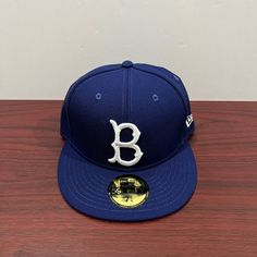 Brand - New Era Hat Model - 59fifty Hat Type - Fitted Team - Brooklyn Dodgers Color - Blue & White Condition- Brand New Classic Blue Baseball Cap With Flat Brim, Classic Blue Baseball Cap, Classic Blue Snapback Fitted Hat, Classic Blue Fitted Baseball Cap, Classic Blue Hats For Sports Events, Classic Blue Hat For Sports Events, Classic Blue Flat Brim Baseball Cap, Blue Flat Crown Hat For Streetwear, Classic Blue Fitted Hat With Curved Brim