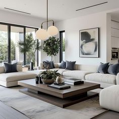 a living room filled with white couches and lots of windows next to each other