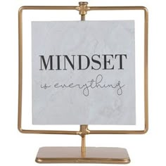 a sign that says mindset is everything on it with a gold frame and marble base