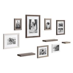 a group of framed pictures hanging on the side of a wall next to a shelf