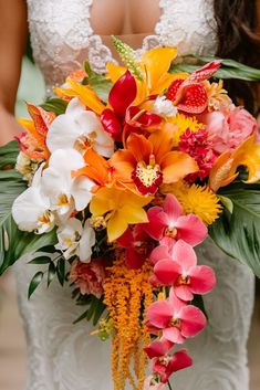 Elegant Tropical Wedding Bouquets Inspired by Vibrant Sunsets Bridal Tropical Bouquet, Tropical Bridal Bouquet Bright Colors, Tropical Wedding Flower Arrangements, Tropical Bouquet Floral Arrangements, Emerald Green Tropical Wedding, Citrus Wedding Flowers, Tropical Flower Bouquet Wedding, Hibiscus Wedding Bouquet, Tropical Flowers Arrangements