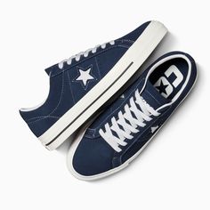 Style No. A04154C Color: Navy/White/Black In 1974, Converse launched a low-cut, suede version of the Chuck Taylor All Star, featuring a single star logo on one side—the One Star sneaker. Reissued in the early '90s, the design gained traction with the skateboarding community thanks to a performance remodel. Today's One Star Pro provides better boardfeel and impact protection thanks to a CONS traction rubber outsole and molded CX sockliner. The low profile adds total flexibility, while a rubber-ba Lounge Fits, Converse One Star Shoes, Converse One Star Pro, Cute Converse Shoes, Navy Converse, Cute Converse, Converse Star, Red Puffer, Red Converse