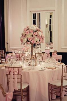 the table is set with pink and white flowers