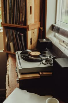 a record player sitting on top of a wooden table