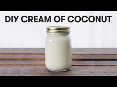 a jar filled with cream sitting on top of a wooden table