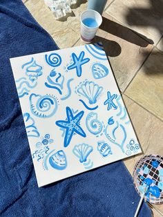 blue and white paper with sea animals on it next to a racket, water bottle and other items