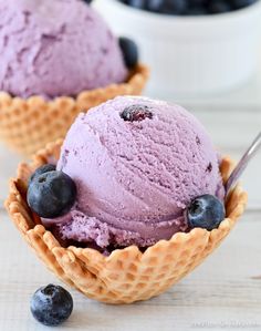 two scoops of blueberry ice cream in waffle cups