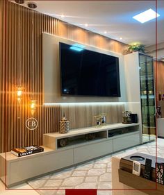 an entertainment center with a flat screen tv mounted on the wall