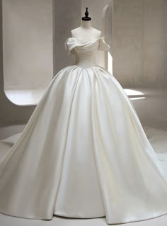 a white wedding dress on display in a room