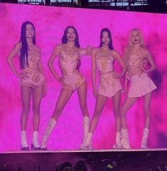 the girls are all dressed in pink outfits