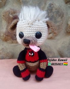 a crocheted stuffed animal with a red and black heart on it's chest