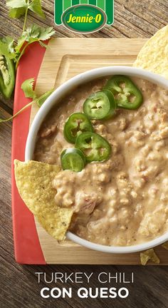 there is a bowl of food on the table with chips and jalapenos