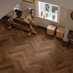 This Elka Herringbone Dark Smoked Oak engineered wood flooring has mixed tone deep grain textures, that really gives this wood a unique look. It is also finished with a UV oil, a must-have to perfect your home. This flooring has a tongue & groove system, and it can be bonded to the sub-floor, or floated with one of our high-quality underlays, or by using our special elasticated, Elka - Bonding Glue. It comes with a 4V bevel to give it a more stylish, authentic look. Engineered Parquet Flooring, Engineered Wood Floors Oak, Herringbone Flooring, Oak Parquet Flooring, Best Laminate, Wood Parquet Flooring, Herringbone Wood